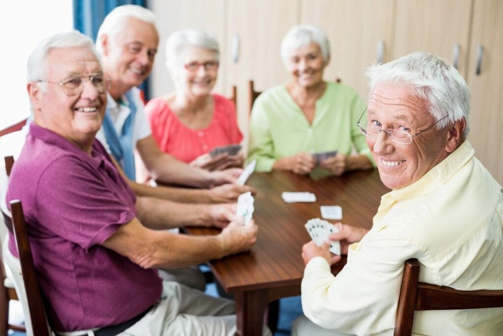 A group of elderly people playing cards